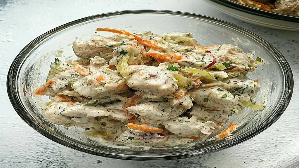 Creamy chicken salad with celery in a bowl, ready for sandwiches or wraps.