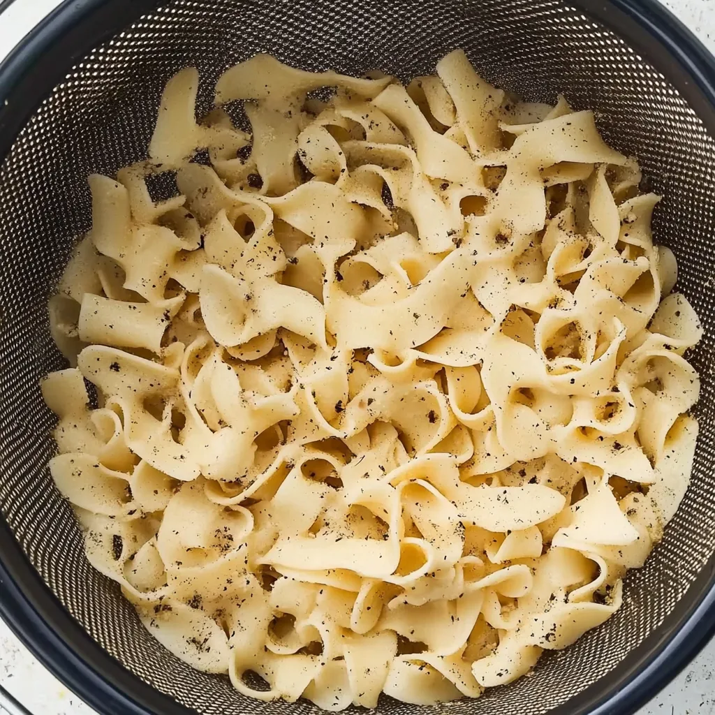 Vegan chicken noodle soup with vegetables in a bowl.